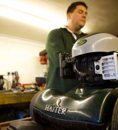 Technician repairing garden machinery